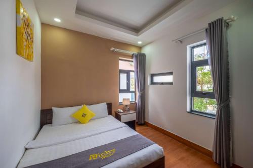 a bedroom with a bed with a yellow star on it at Richy Dalat Hotel in Da Lat