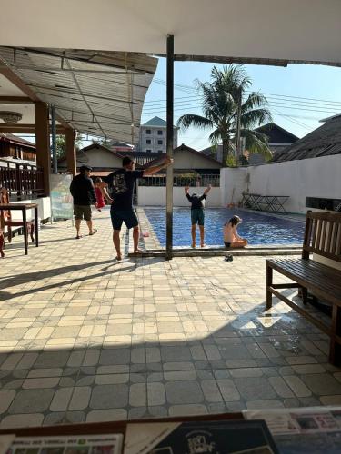 a group of people playing in a swimming pool at Vang Vieng Global Hostel in Vang Vieng