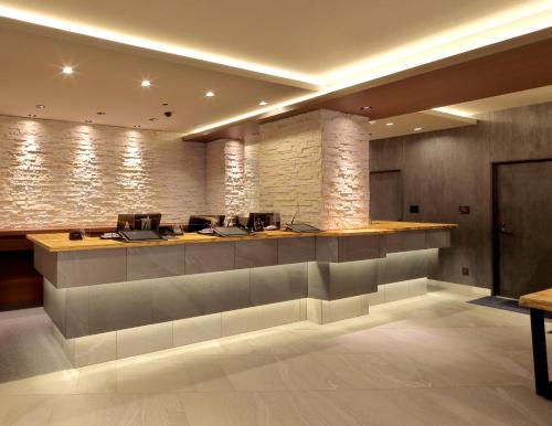 a lobby with a reception desk at Hotel SUI Kobe Sannomiya by ABEST in Kobe