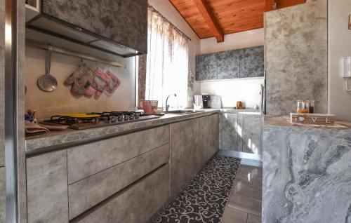 a kitchen with a stove and a counter top at Beautiful Home In Acireale With Wifi in Acireale