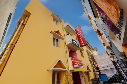 a yellow building with signs on the side of it at SPOT ON RKH Inn in Chennai
