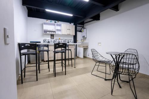 a kitchen with a table and chairs in a room at Coliving Tonchala in Medellín