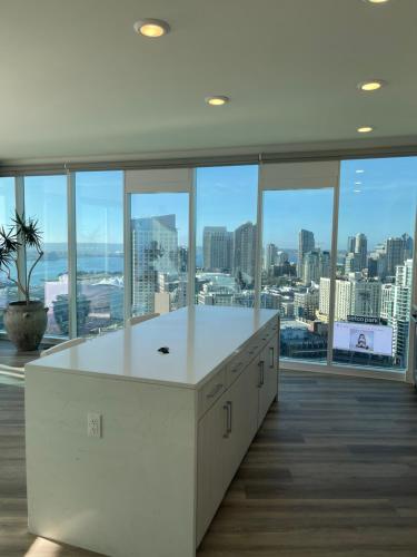 a large white kitchen with a view of the city at Massive Penthouse Overlooking All of San Diego in San Diego