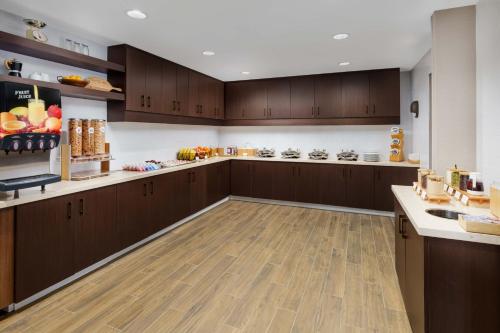 a large kitchen with wooden cabinets and wooden floors at Residence Inn by Marriott New Haven Hamden in Hamden