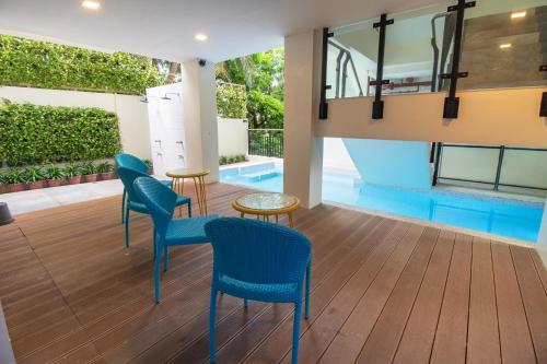 a lobby with blue chairs and a swimming pool at Bloom Boracay in Boracay