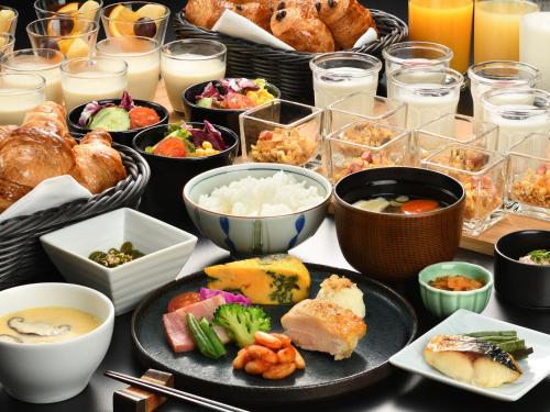 a table with a bunch of different types of food at Towada Prince Hotel in Kosaka