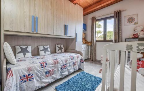a childs bedroom with a bed and a crib at Beautiful Home In Acireale With Wifi in Acireale