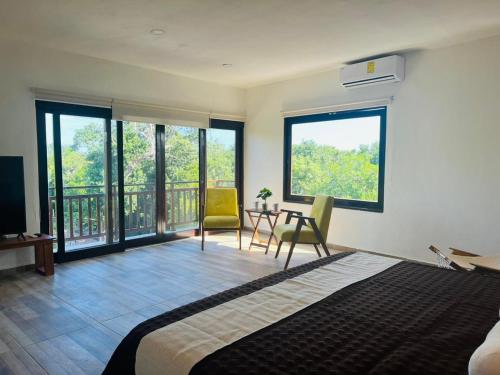 Ένα ή περισσότερα κρεβάτια σε δωμάτιο στο Villa & Studios Kosom Aldea Ha Puerto Morelos