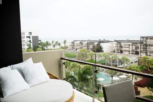 a balcony with a bed and a view of a resort at Villa seaview and apartment -Spa Da Nang Resort by JT group "Free pick up" in Da Nang