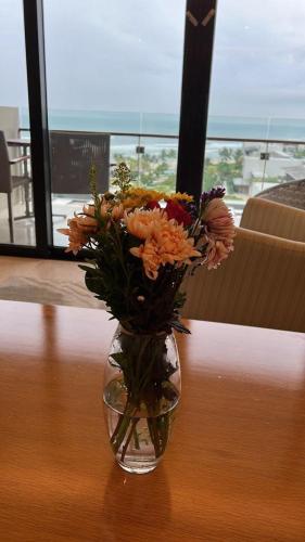 a vase filled with flowers sitting on a table at Villa seaview and apartment -Spa Da Nang Resort by JT group "Free pick up" in Da Nang