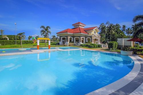 a large swimming pool in front of a house at Modern 4 Bedroom House I Close to Malls I Swimming Pool I Maximum 12 Guests I by Bleuspace in Tagum