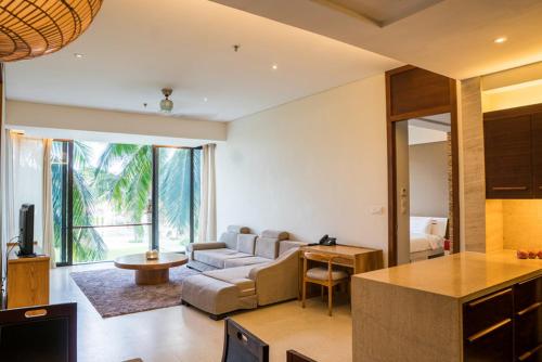 a living room with a couch and a table at Villa seaview and apartment -Spa Da Nang Resort by JT group "Free pick up" in Da Nang