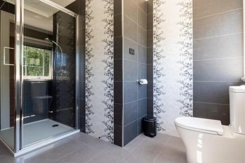 a bathroom with a shower and a toilet at Gorgeous on Galvin: Close to Town Yet A Mile Away in Kings Park