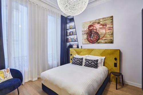 a bedroom with a bed and a large window at Designer luxury flat in Central Paris - 2bed 2bath with AC in Paris