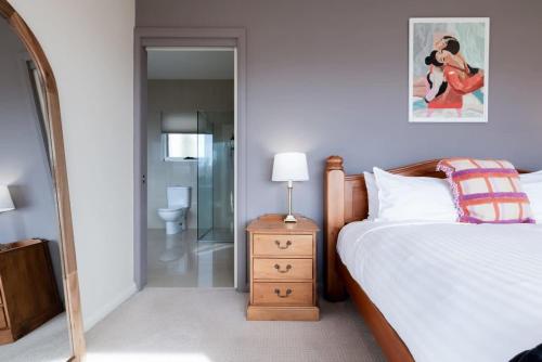 a bedroom with a bed and a walk in shower at Riverview Escape in Inveresk