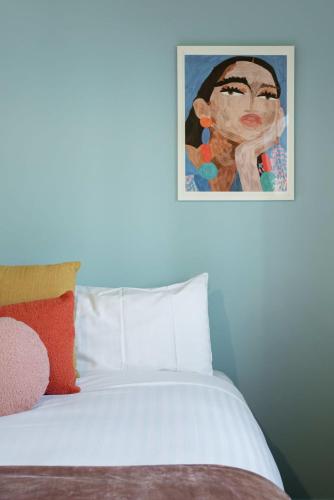 a bedroom with a bed with a painting on the wall at Riverview Escape in Inveresk