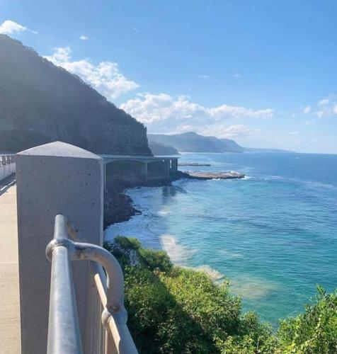 a view of the ocean from a balcony at Ocean Vista Escape - A Lofty Beachfront Penthouse in Wollongong