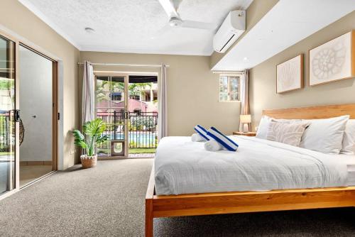 a bedroom with a large bed and a window at Reef Apartment Cairns in Edge Hill