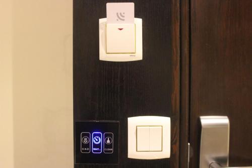 a refrigerator with a cell phone on a wall at Ertiaad Tabuk for Hotel Apartment in Tabuk