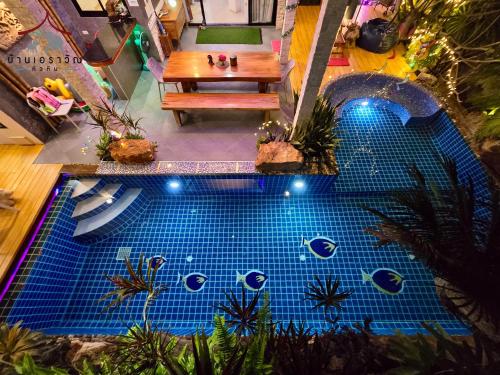 a model of a pool with a table and a bench at Arawan Pool Villa Hua Hin in Hua Hin