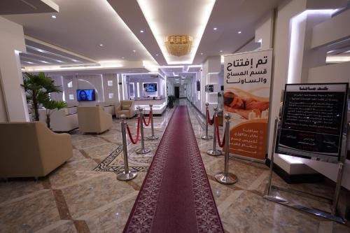 a room with a red carpet in the middle of a building at Hotel and Apartments Al Raqi Mall Artiaad in Tabuk