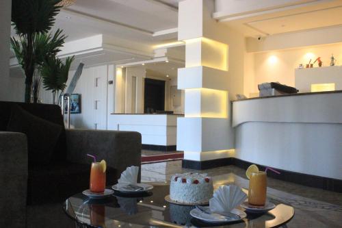 a living room with a cake and candles on a table at Hotel and Apartments Al Raqi Mall Artiaad in Tabuk