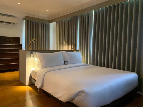 Кровать или кровати в номере The Henry Suites MiraNila Quezon City