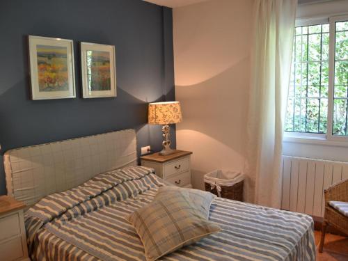 a bedroom with a bed and a lamp and a window at Villa Mimosa - Tamariu, Aigua Gelida - ES-323-61 in Palafrugell