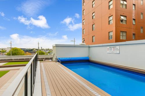 a swimming pool on the roof of a building at Zodiak Stays Cozy CBD 2BR Near Top Dining Spots in Auckland