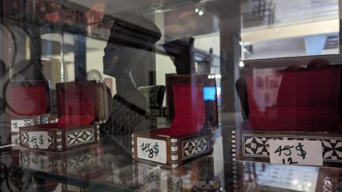 a glass display case with red vases with writing on it at Eileen Hotel Cairo in Cairo