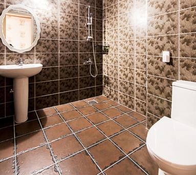 a bathroom with a toilet and a sink at Milmo Resort Family Hotel in Muju