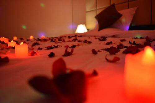 a group of candles on a bed in a room at Ertiaad Tabuk for Hotel Apartment in Tabuk