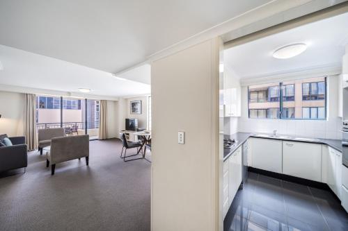 an open kitchen and living room in a apartment at Oaks Sydney Castlereagh Suites in Sydney