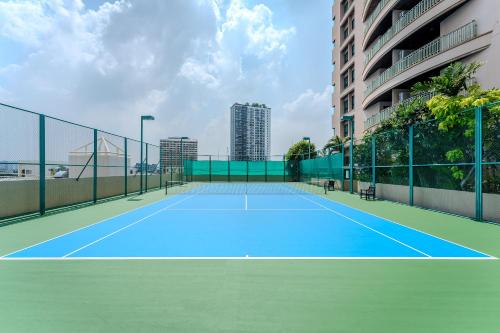 a tennis court in front of a building at Somerset Park Suanplu Bangkok in Bangkok