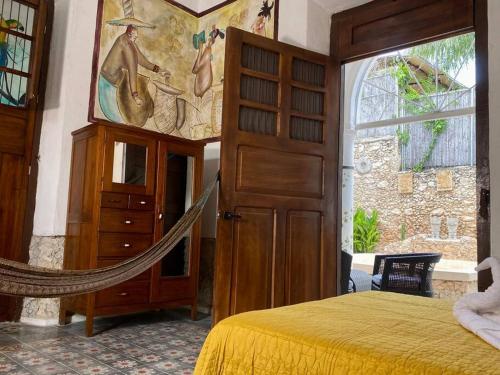 a bedroom with a bed with a hammock in it at Casa Iktal Luxury - Centro Mérida in Mérida