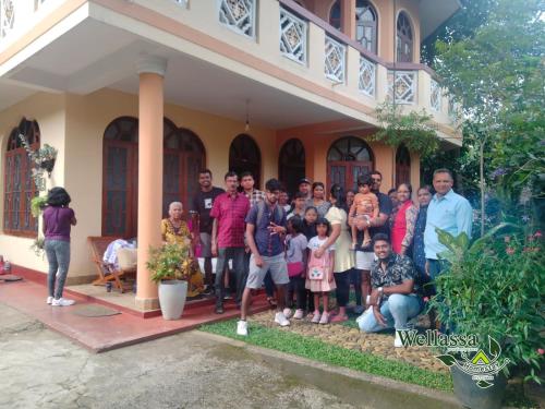 a group of people standing in front of a house at wellassa homestay in Badulla