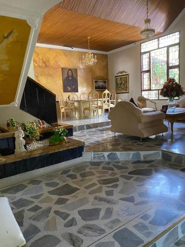 a large living room with a couch and a fireplace at Valle Suites, la Mejor Ubicación in Valledupar