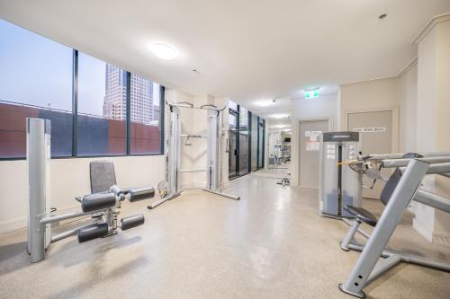a gym with cardio equipment in a building at Oaks Sydney Castlereagh Suites in Sydney