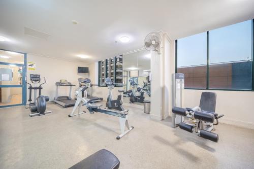 a gym with several treadmills and cardio machines at Oaks Sydney Castlereagh Suites in Sydney