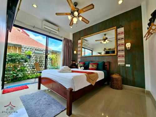 a bedroom with a bed and a large mirror at Arawan Pool Villa Hua Hin in Hua Hin