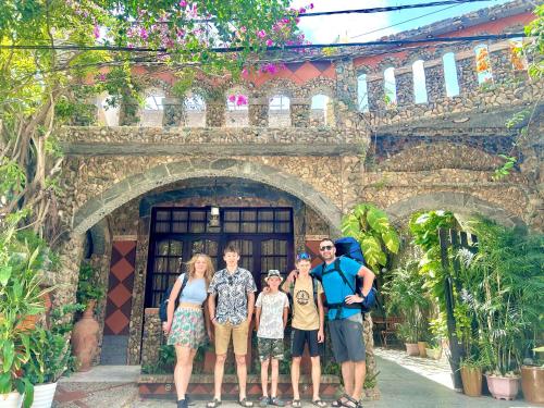 a group of people standing in front of a building at Sầm Sơn Boutique Hotel Phan Thiết in Phan Thiet
