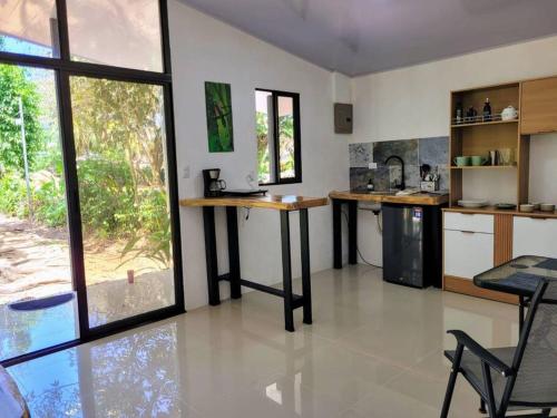 a kitchen with a counter and a table in it at Luba house in Puerto Jiménez
