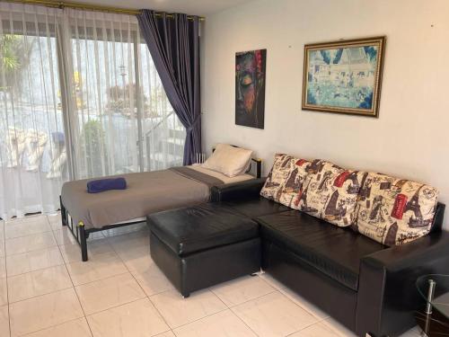 a living room with a couch and a bed at Blue Sky Villa in Karon Beach