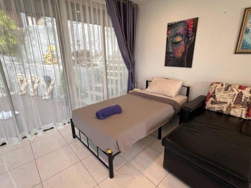 a bedroom with two beds and a window at Blue Sky Villa in Karon Beach