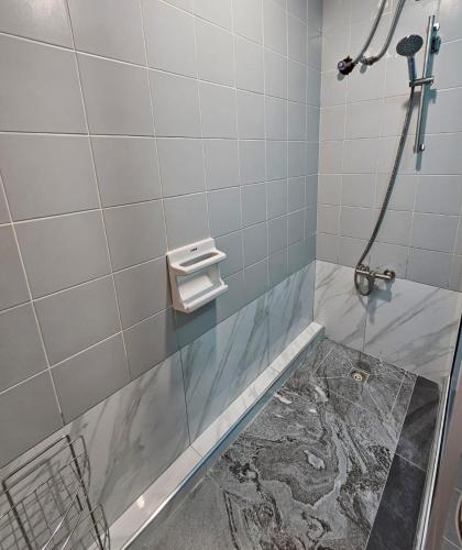 a bathroom with a shower stall with a sink at Patong Tower Apartment in Patong Beach