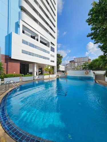 a large swimming pool in front of a building at Patong Tower Apartment in Patong Beach