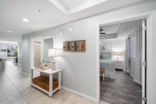 a living room with a table and a bed at Gulfside 210 - 2BR plus bunkroom with Ocean & Pool Views in Fort Walton Beach