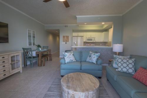 a living room with a couch and a table at Destin West Gulfside 209 - You Own Slice of Paradise! - Ocean Views - Free Beach Service! in Fort Walton Beach