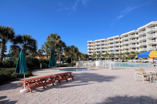 a resort with benches and umbrellas and a pool at Destin West Gulfside 209 - You Own Slice of Paradise! - Ocean Views - Free Beach Service! in Fort Walton Beach