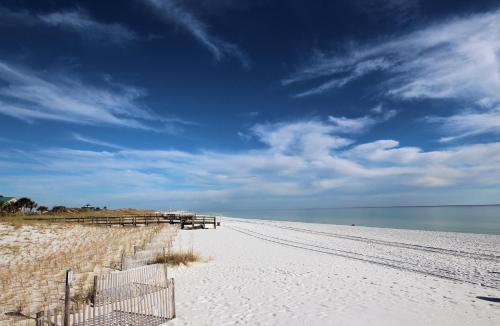 a beach with a fence on it and the ocean at Destin West Gulfside 209 - You Own Slice of Paradise! - Ocean Views - Free Beach Service! in Fort Walton Beach
